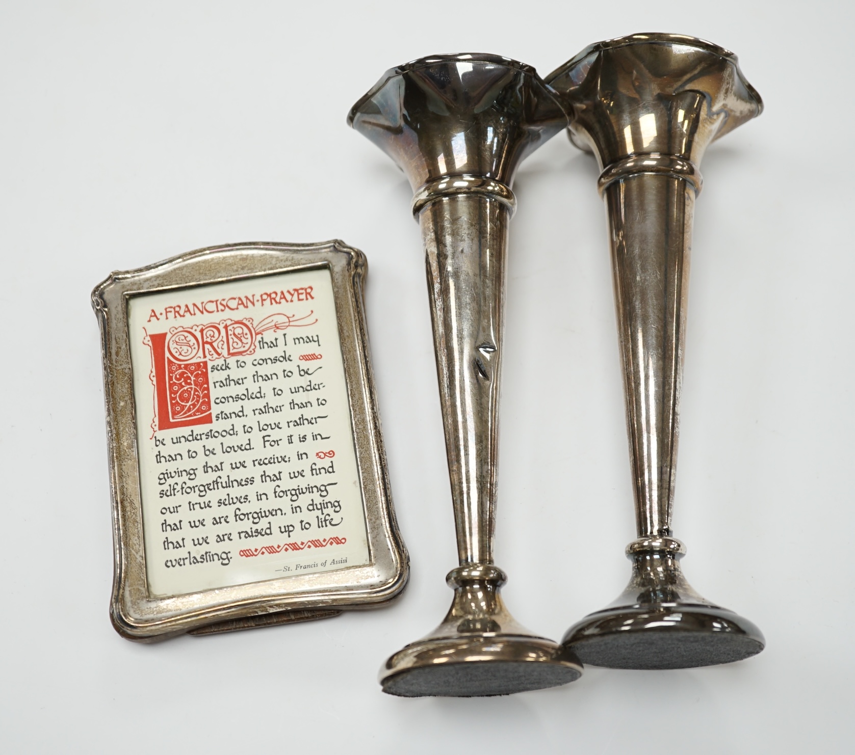 A pair of 1940's silver trumpet vases, 19.7cm, weighted, and a George V silver mounted photograph frame. Condition - poor